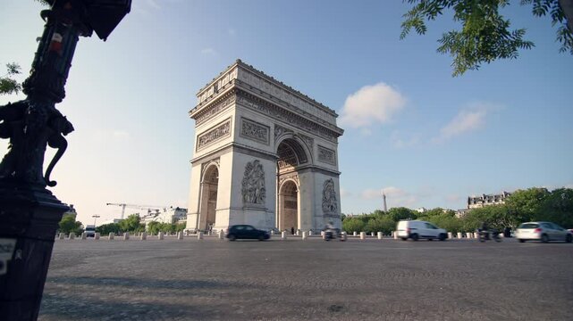 Arc de Triomphe Paris cityscape. Beautiful streets traffic on the roads historical architecture of the capital of France, travel and tourism in Europe.