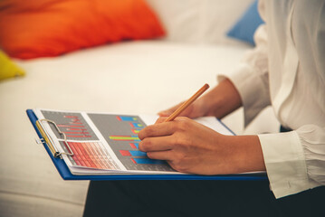 Woman hands writing empty notebook planing meeting agenda on wooden table. Close up women hands...