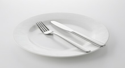Simple white plate with a fork and knife, ready for a meal.
