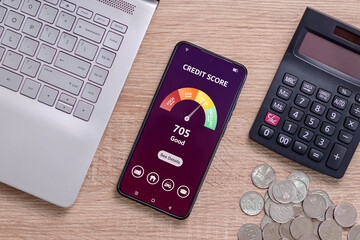 A smartphone on a desk with credit score on the phone screen. Online credit score ranking check to...