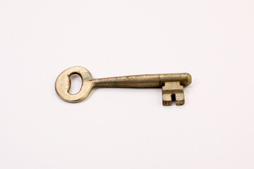 Old rusty door key isolated on white.