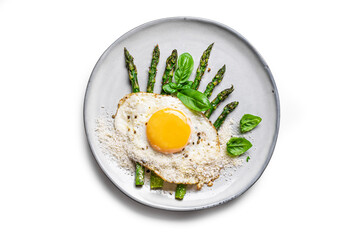 Fried egg with green asparagus and grated parmesan cheese isolated on white