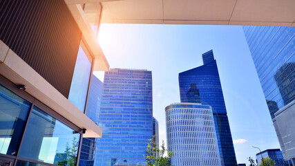 Downtown corporate business district architecture. Glass reflective office buildings against blue...