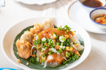 A vibrant plate of delicious dumplings topped with fresh herbs and sauces, perfect for food lovers and culinary enthusiasts.
