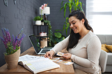 Smiling woman calculating her home finances