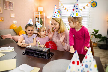 Joyful celebration with children and cake in a cozy living room