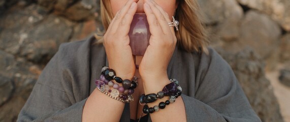 Close-up of female hands holding natural healing stones. Tools for energy balance, emotional...