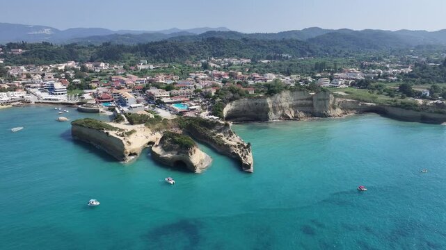 4k aerial video footage flying toward and descending to "Kanali tou erota" beach with rapid quick panning - area round Sidari Cityscape in background - located on Corfu Island  