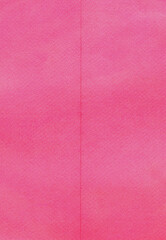 scan of a folded pink paper texture. The surface features a subtle paper grain and a vertical...