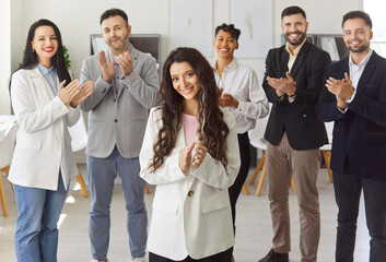 Happy diverse group of colleagues clapping, celebrating achievement, woman leader applauses to show success, collective happiness, appreciation, positive professional situation, team accomplishment