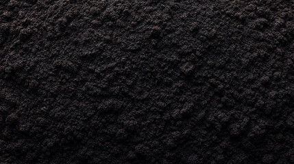 Rich black compost soil texture harvested from homemade pile, showing moist and fertile organic material for gardening