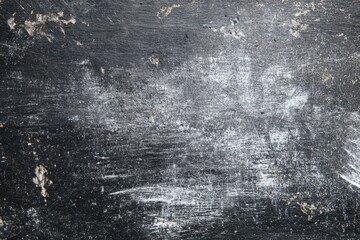 Weathered black texture with white scuffs ideal for grunge aesthetics and industrial design applications in contemporary art and marketing projects