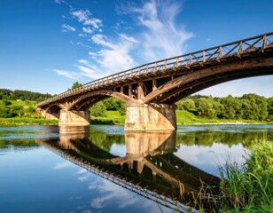 Fototapeta premium Old wooden bridge over calm river
