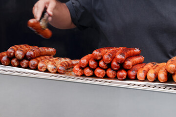 Grilled Sausages Stacked On Outdoor Barbecue Grill