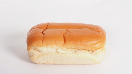 A loaf of soft and golden brown bread on white background.