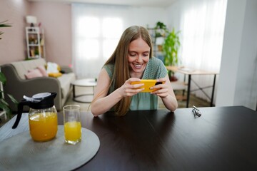 Young woman enjoying her time while playing games at home