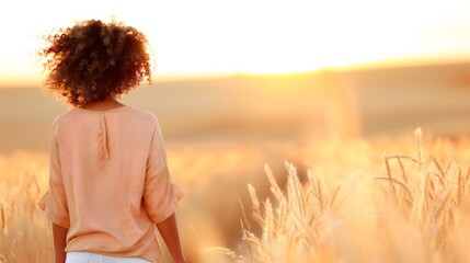 Person Standing In Wheat Field At Sunset With Sparkling Top And Golden Sunlight