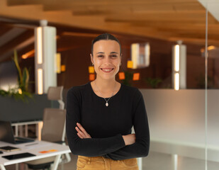 Portrait of a working woman, smiling at the office in the office