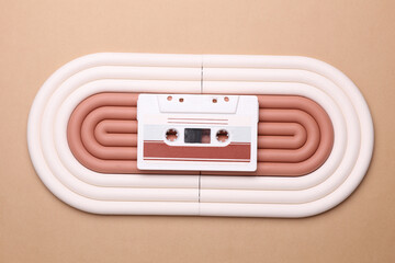 Geometric line podium with retro audio cassette on beige background.