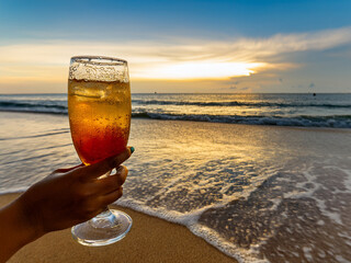 Italian soda drinks with strawberries and citrus photographed at the beach during sunset