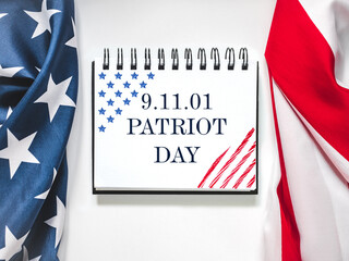 Patriot Day. We will never forget. American flag and lettering. Closeup, isolated background....