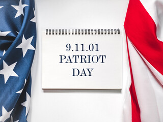 Patriot Day. We will never forget. American flag and lettering. Closeup, isolated background....