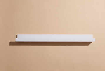 Empty white wall shelf on beige background
