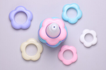 Children's plastic pyramid on a gray background. Top view