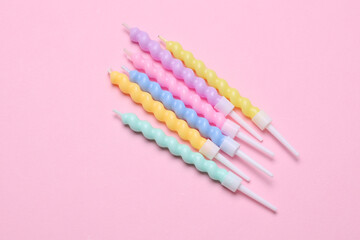 Spiral birthday candles on pink background