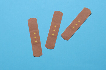 Medical Adhesive bandage plasters on blue background