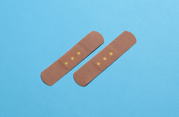 Medical Adhesive bandage plasters on blue background