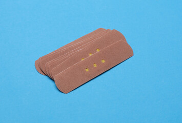 Medical Adhesive bandage plasters on blue background