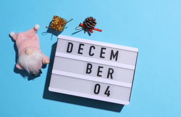 Lightbox calendar with text December 04 with Christmas, New Year winter decor on blue background