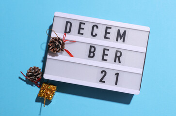 Lightbox calendar with text December 21 with Christmas, New Year winter decor on blue background