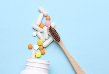 Toothbrush and pills on a blue background