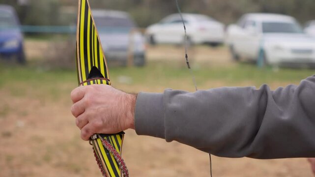an archer pulls the bowstring and shoots a bow