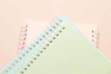 Spiral binding notebooks on beige background