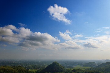 Fototapeta premium Scenic View of a Mountainous Landscape Under a Bright Blue Sky, bright sky, summer concept, beautiful blue color, natural light.