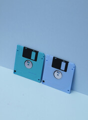 Outdated technologies. Retro 80s floppy disks on blue background. Creative layout