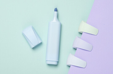 Markers or colored felt-tip pens on a pastel background. Top view. Creative layout