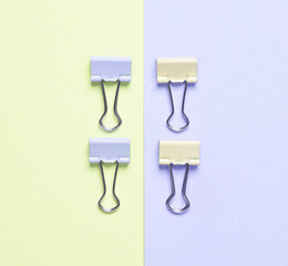 Paper clip holders on pastel background. Minimalism. Creative layout