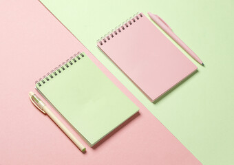 Two notebooks with a pens on pastel background. Minimalism. Creative layout
