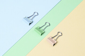 Paper clip holders on a pastel background. Minimalism, creative layout
