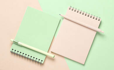 Two notebooks with a pens on pastel background. Minimalism. Creative layout