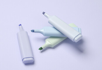 Markers or colored felt-tip pens on purple pastel background. Creative layout
