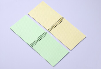 Two open notebooks on purple pastel background. Minimalism. Creative layout