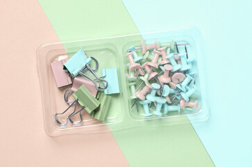 Set Paper clip holders and pins on a pastel background. Minimalism. Creative layout