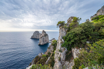 Faraglioni rock formation along the coast of Capri Island, Gulf of Naples, Campania, Italy