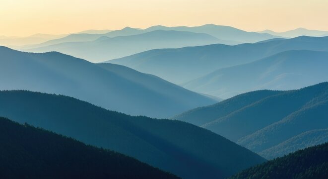 Layered blue mountain ranges at sunrise mountains landscape