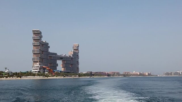 Palm Jumeirah view featuring the luxurious Atlantis The Royal hotel with its iconic architecture against clear blue skies. 